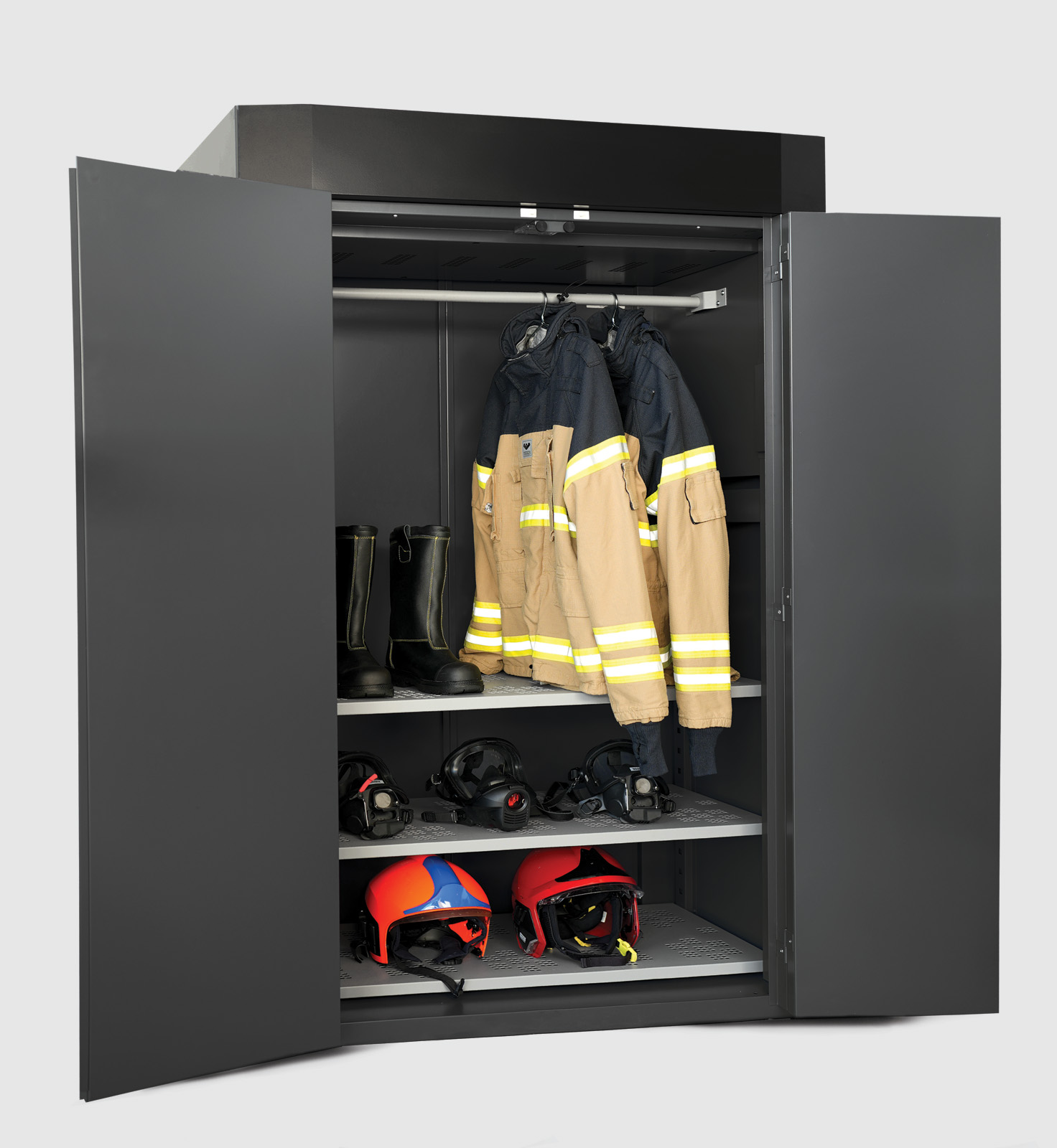 Open drying cabinet with firefighter jackets, boots, black helmets, and red helmets neatly arranged on shelves.